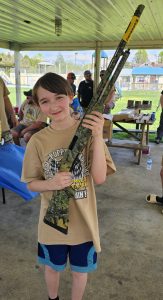 "Award ceremony at the Roscoe Spaulding Memorial Turkey Hunt, with hunters receiving prizes like shotguns and hunting vests."