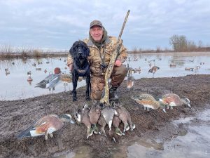 Hunter and his dog on a duck hunt