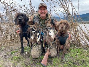 Scott Haugen, with his Pudelpointer puppies, Kona and Echo, both pudelpointers