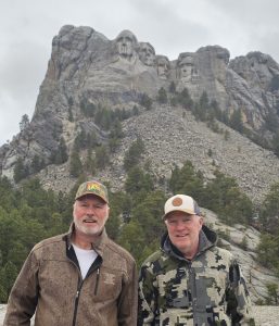 Bill and author in front of Mt Rushmore