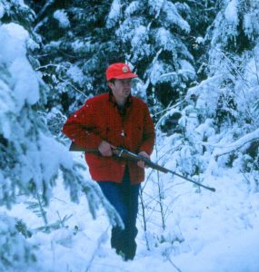 Hunter in the woods with a gun
