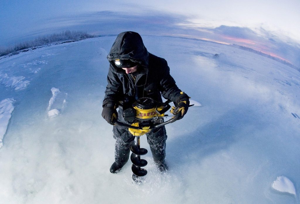 The Best Ice Augers: Gas or Electric? Tested and Reviewed drilling an ice fishing hole