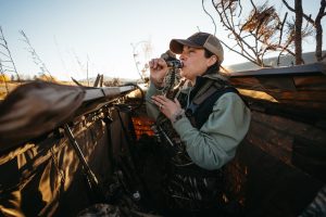 Erin Crider calling ducks in a blind
