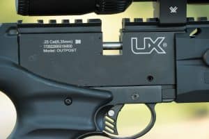 A close-up of the Umarex Outpost shows the .25-caliber receiver, two-stage adjustable trigger and extended Picatinny rail used for mounting optics.