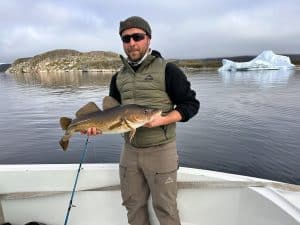John Webber with an Atlantic cod caught while Greenland caribou hunting