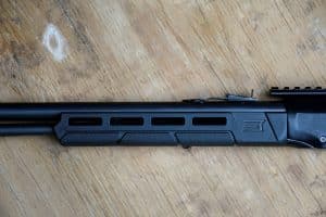 Detail of the Savage Revel Tactical synthetic forend showing M-LOK accessory slots and textured grip panels.