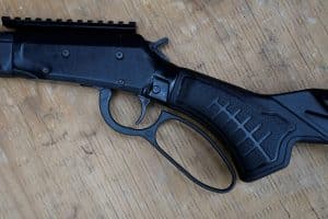 Close-up of the Savage Revel Tactical receiver, trigger, oversized lever loop and textured pistol grip.